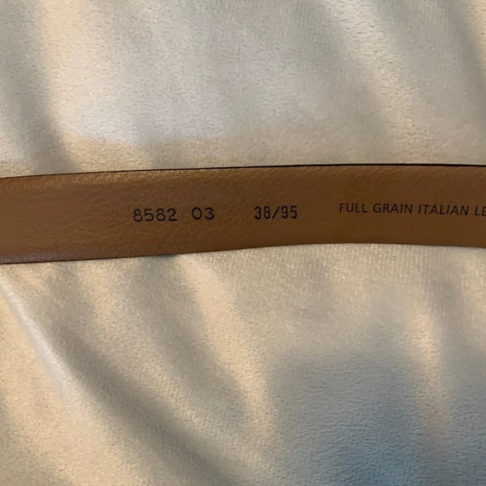The mens warehouse smooth brown leather belt made in Italy size 38 thin dressy